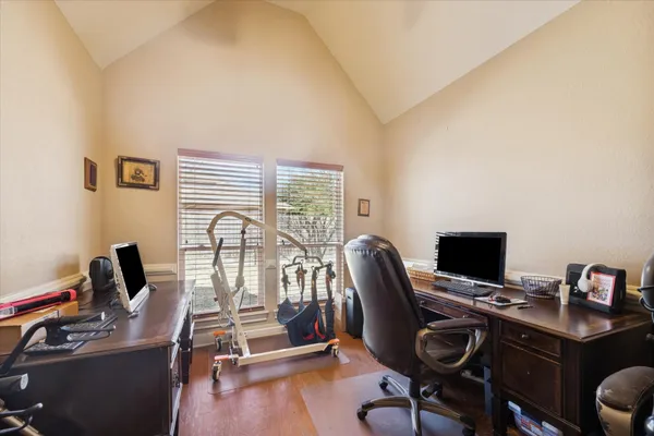 a view of a workspace with furniture and a window