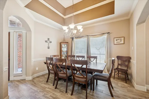 a view of a dining room with furniture and chandelier