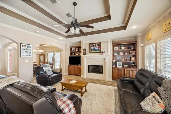 a living room with furniture or chandelier and a fireplace