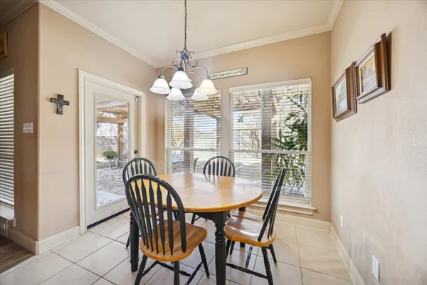 a view of a dining room with furniture wooden floor and chandelier