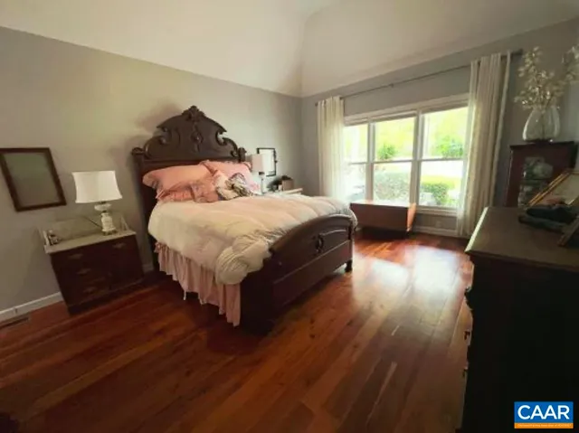 a bed sitting in a bedroom next to a window