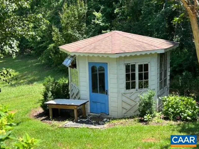 a backyard of a house with table and chairs