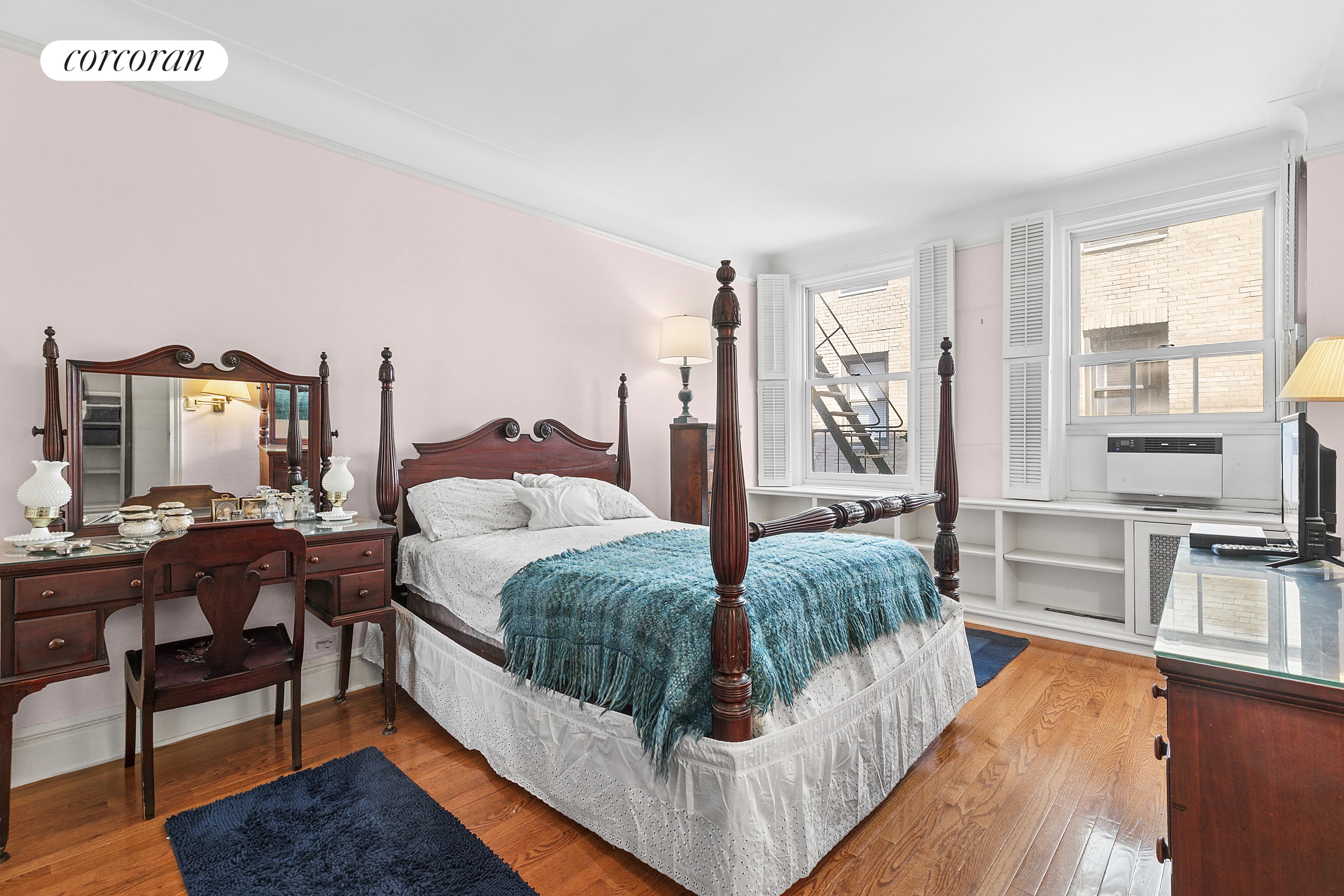 17 East 89th Street, Unit 8E Manhattan, NY 10128 - Photo 2 of 9 a living room with furniture and a flat screen tv