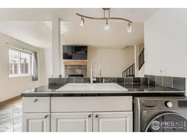 a kitchen with a sink and a refrigerator