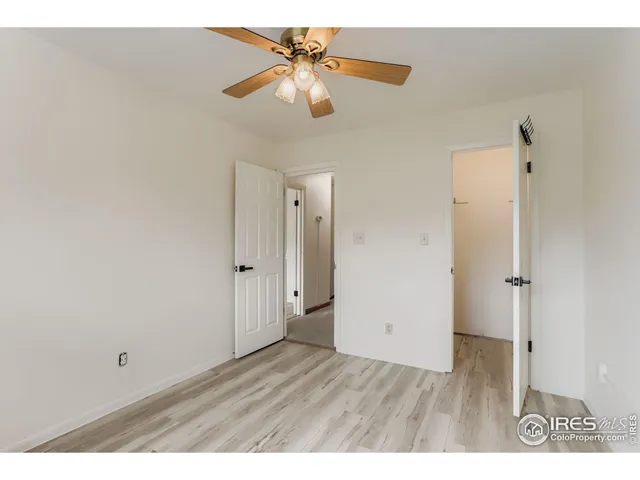 a view of an empty room and a ceiling fan