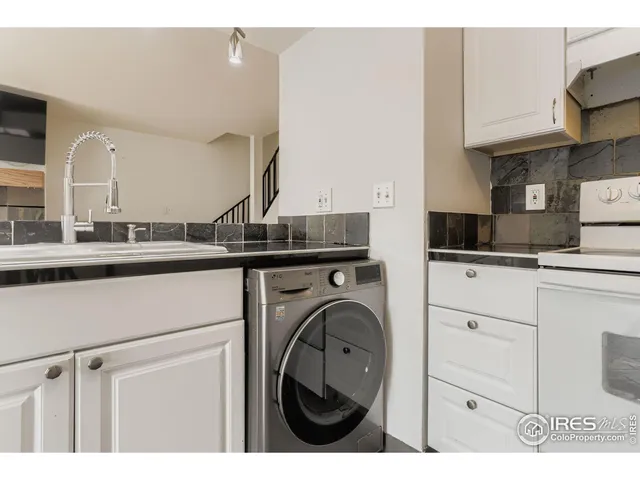a kitchen with kitchen island a sink stainless steel appliances and cabinets