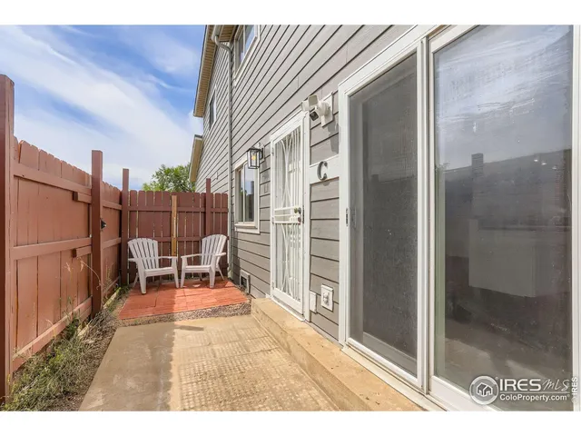 a backyard of a house with table and chairs