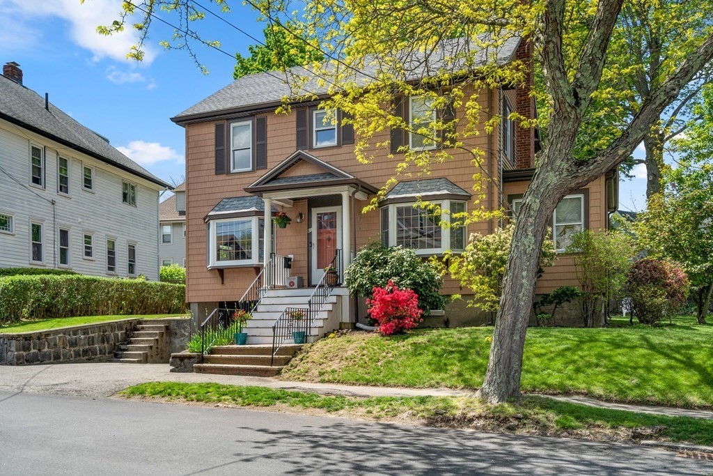 61 Waldeck Road Milton, MA 02186 - Photo 1 of 31 a front view of a house with a yard and potted plants