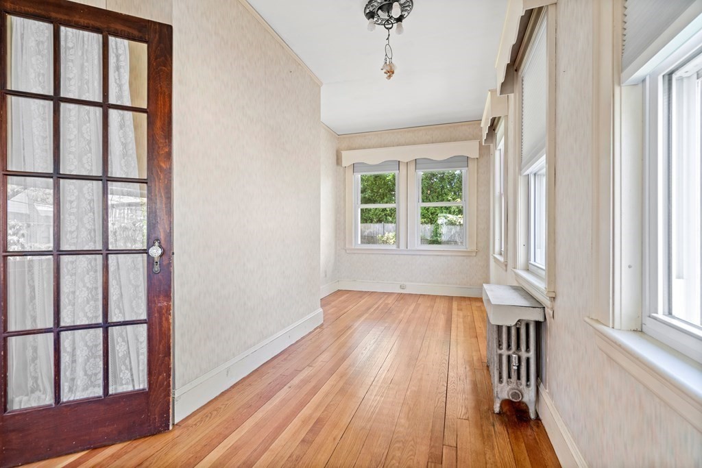61 Waldeck Road Milton, MA 02186 - Photo 15 of 31 a view of empty room with wooden floor and fan