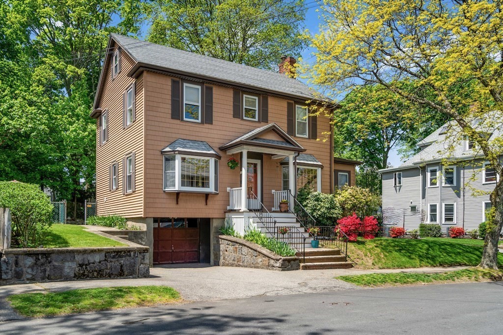 61 Waldeck Road Milton, MA 02186 - Photo 2 of 31 a front view of a house with a garden and plants