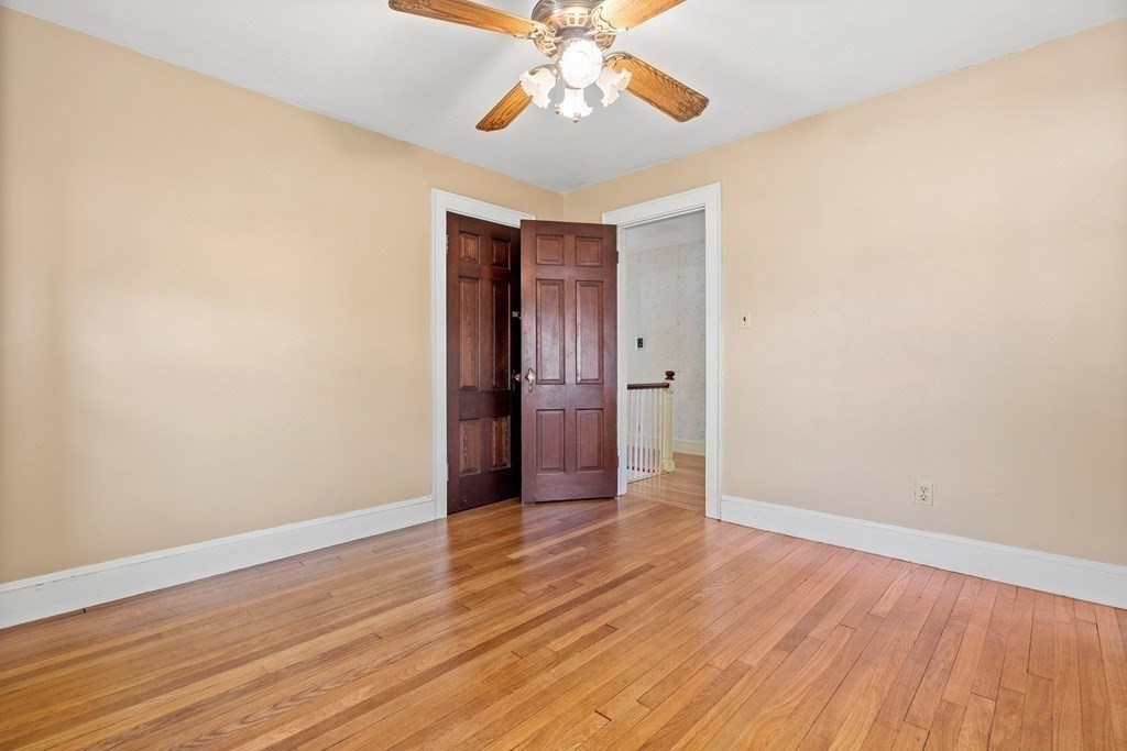 61 Waldeck Road Milton, MA 02186 - Photo 22 of 31 a view of an empty room with wooden floor