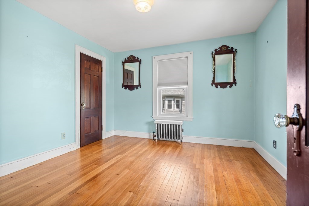 61 Waldeck Road Milton, MA 02186 - Photo 23 of 31 an empty room with wooden floor and a ceiling fan