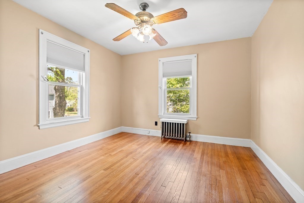 61 Waldeck Road Milton, MA 02186 - Photo 24 of 31 wooden floor in an empty room with a window