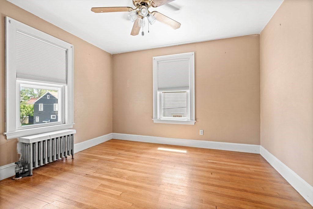 61 Waldeck Road Milton, MA 02186 - Photo 25 of 31 a view of an empty room with wooden floor and a window