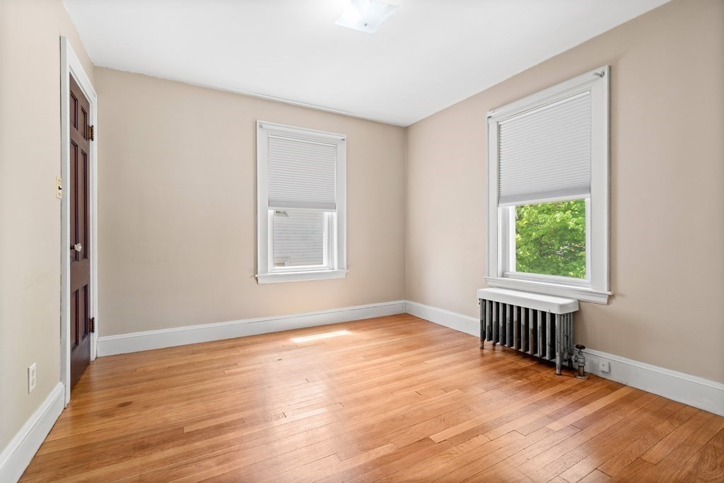 61 Waldeck Road Milton, MA 02186 - Photo 26 of 31 a view of an empty room with wooden floor and a window