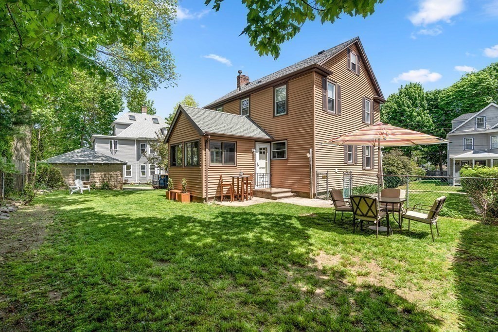61 Waldeck Road Milton, MA 02186 - Photo 27 of 31 a front view of a house with a yard table and chairs