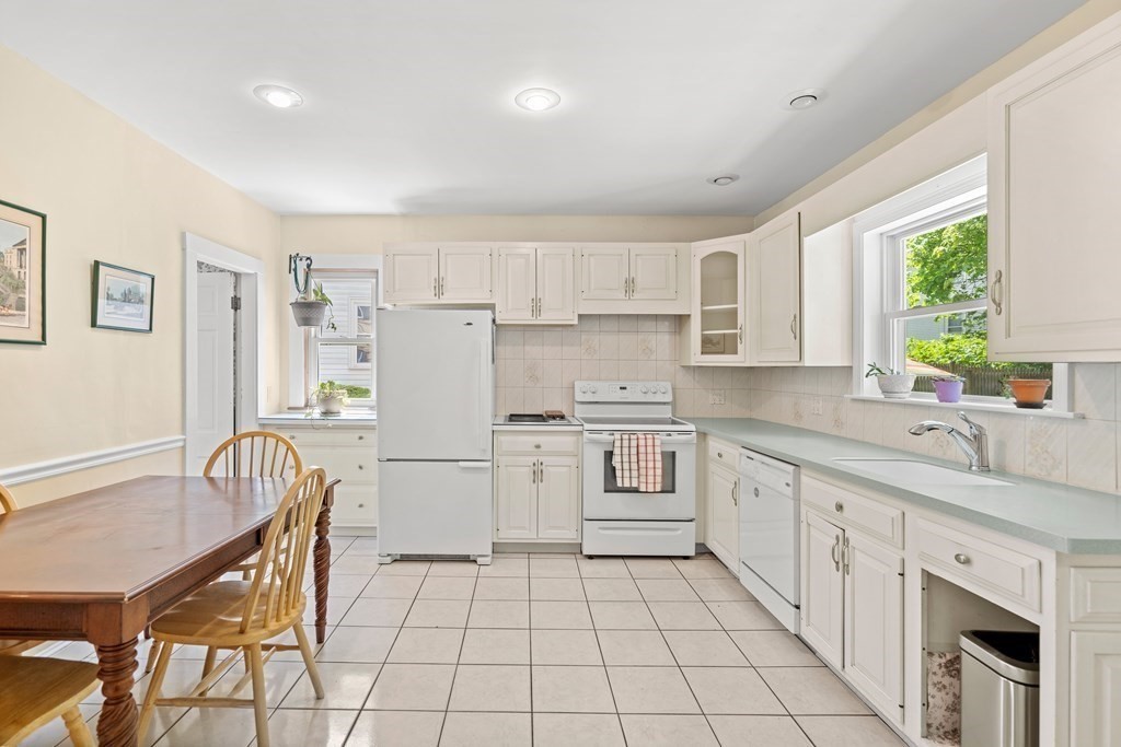 61 Waldeck Road Milton, MA 02186 - Photo 4 of 31 a kitchen with a stove a sink and a refrigerator
