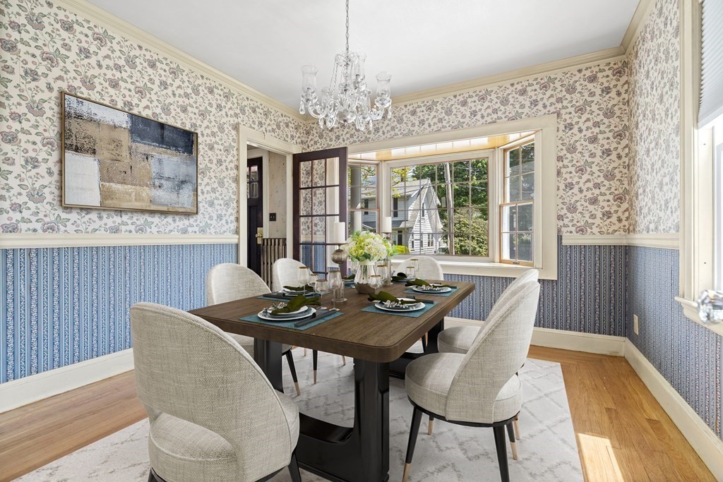 61 Waldeck Road Milton, MA 02186 - Photo 9 of 31 a dining room with furniture a rug and wooden floor