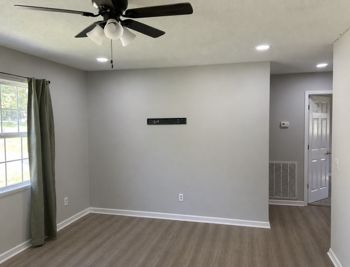 310 Indian Mound Road, Unit B Manchester, TN 37355 - Photo 3 of 7 an empty room with wooden floor fan and windows