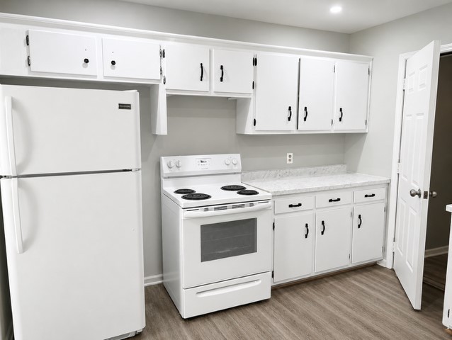 310 Indian Mound Road, Unit B Manchester, TN 37355 - Photo 4 of 7 a kitchen with granite countertop white cabinets and white appliances