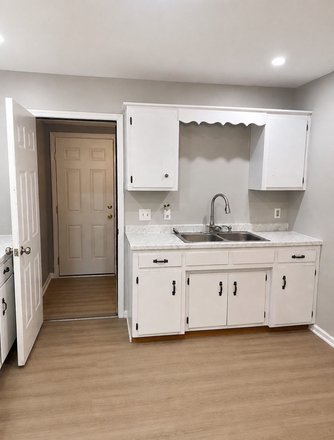 310 Indian Mound Road, Unit B Manchester, TN 37355 - Photo 5 of 7 a kitchen with granite countertop white cabinets and sink