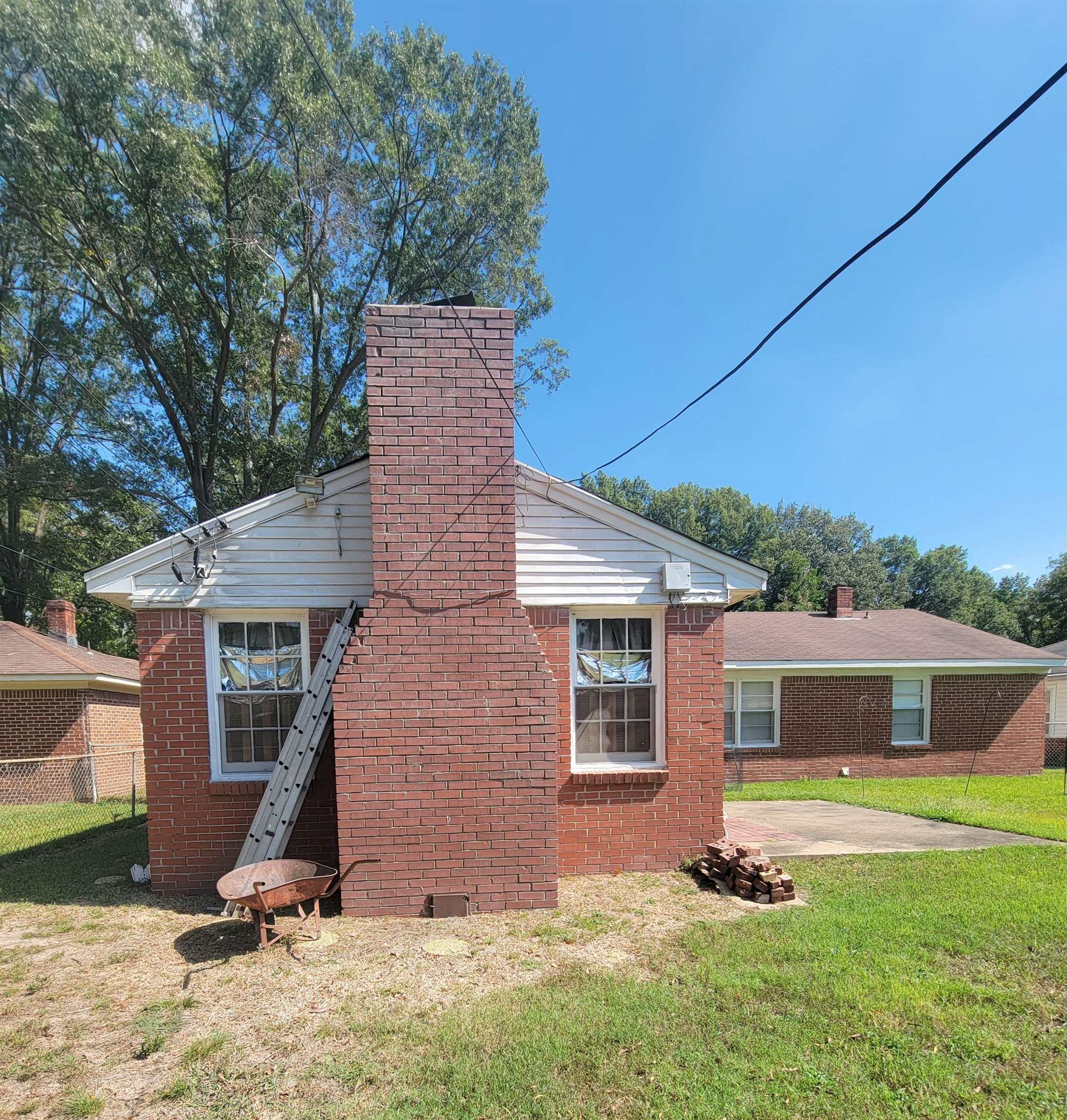 1263 South Perkins Road Memphis, TN 38117 - Photo 26 of 35 view of the back of home and the masonry fireplace chimney