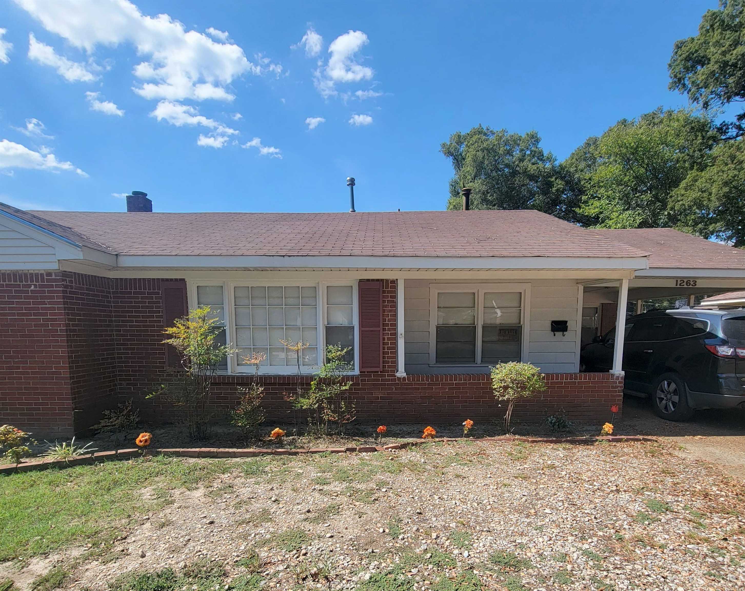 1263 South Perkins Road Memphis, TN 38117 - Photo 7 of 35 a front view of a house with a yard and potted plants