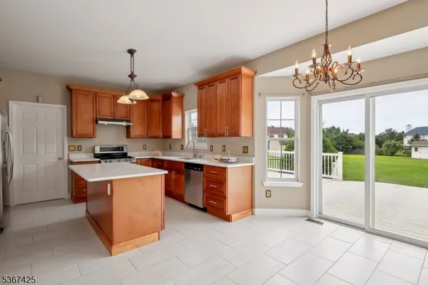 a open kitchen with stainless steel appliances granite countertop a stove and refrigerator