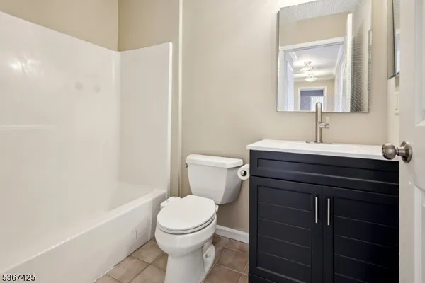 a bathroom with a sink vanity mirror and toilet