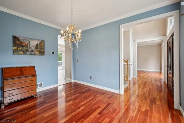 a view of a room with wooden floor and window