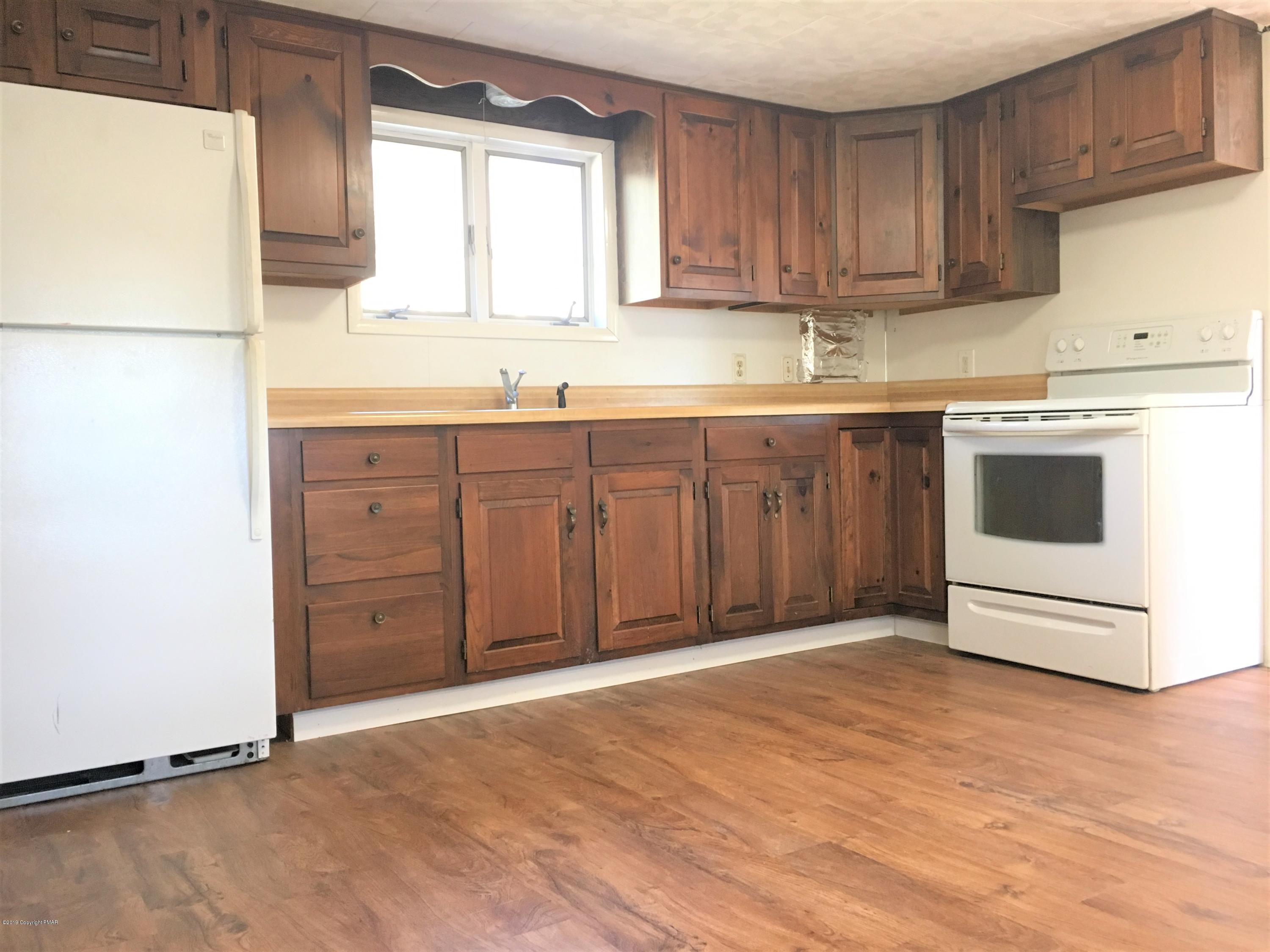 5736 Neola Road Stroudsburg, PA 18360 - Photo 11 of 37 a view of kitchen with granite countertop cabinets and white appliances