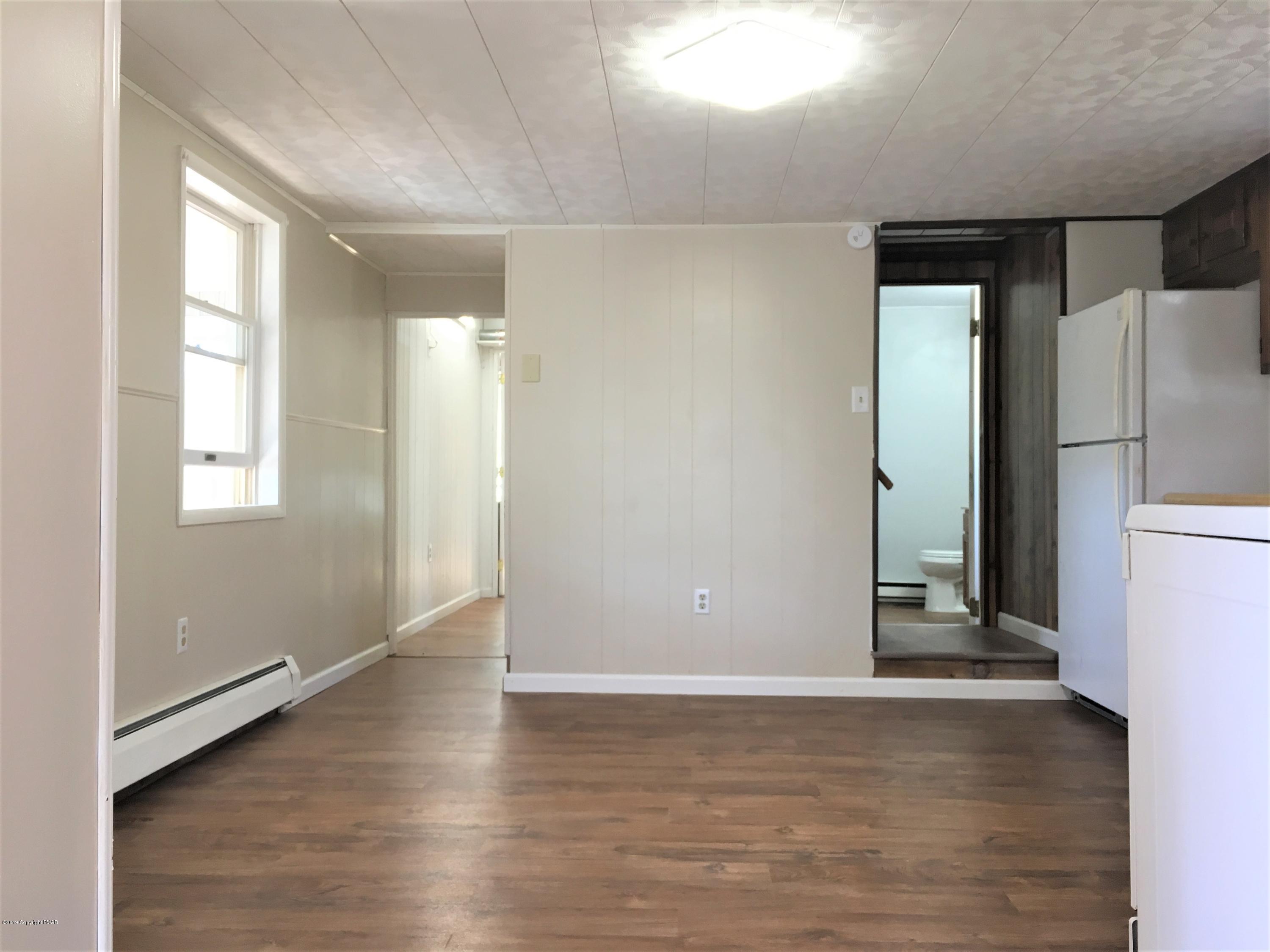 5736 Neola Road Stroudsburg, PA 18360 - Photo 12 of 37 an empty room with wooden floor and windows