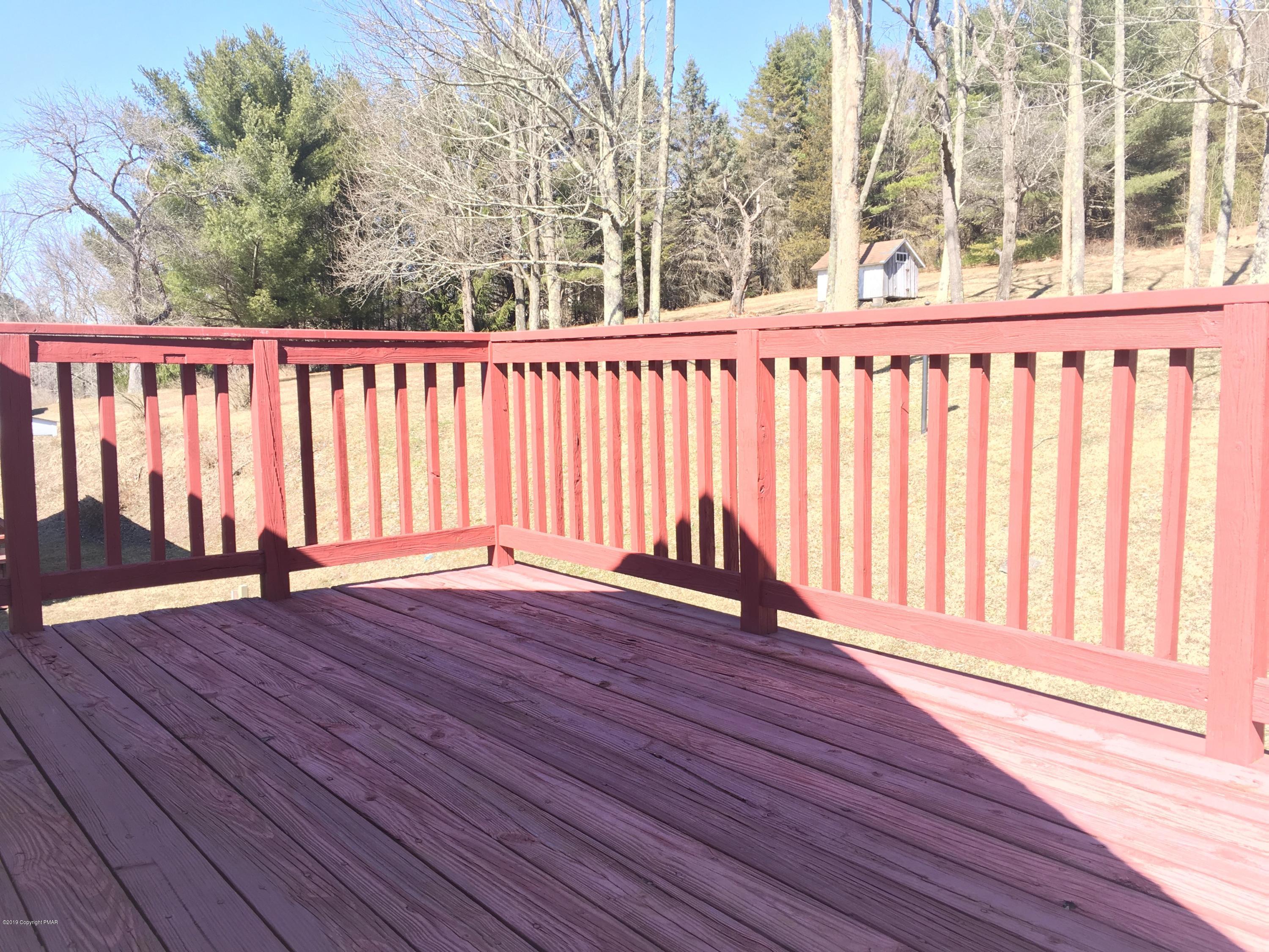 5736 Neola Road Stroudsburg, PA 18360 - Photo 26 of 37 an empty room with wooden floor and iron fence