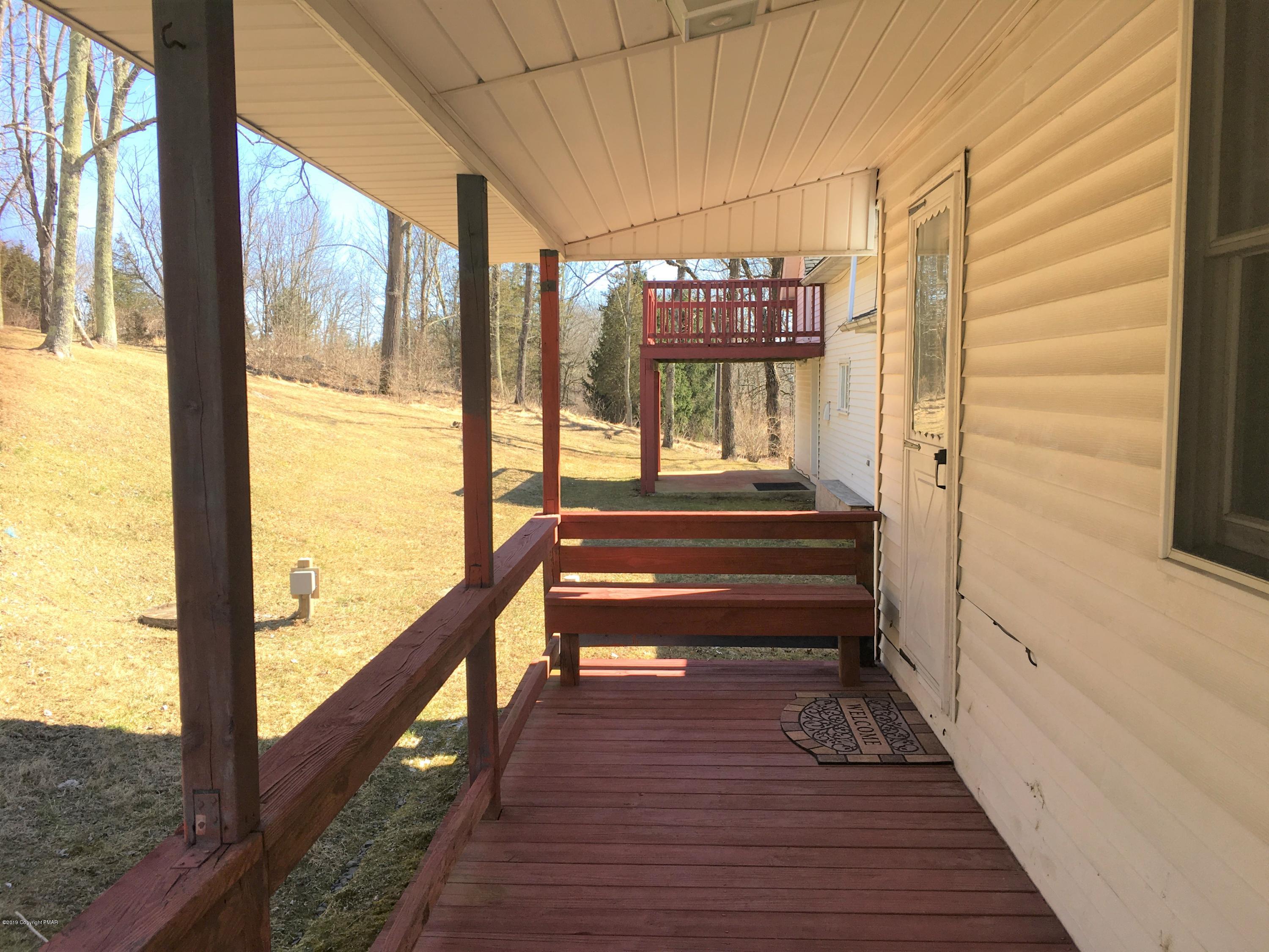5736 Neola Road Stroudsburg, PA 18360 - Photo 28 of 37 a view of a balcony with wooden floor and stairs