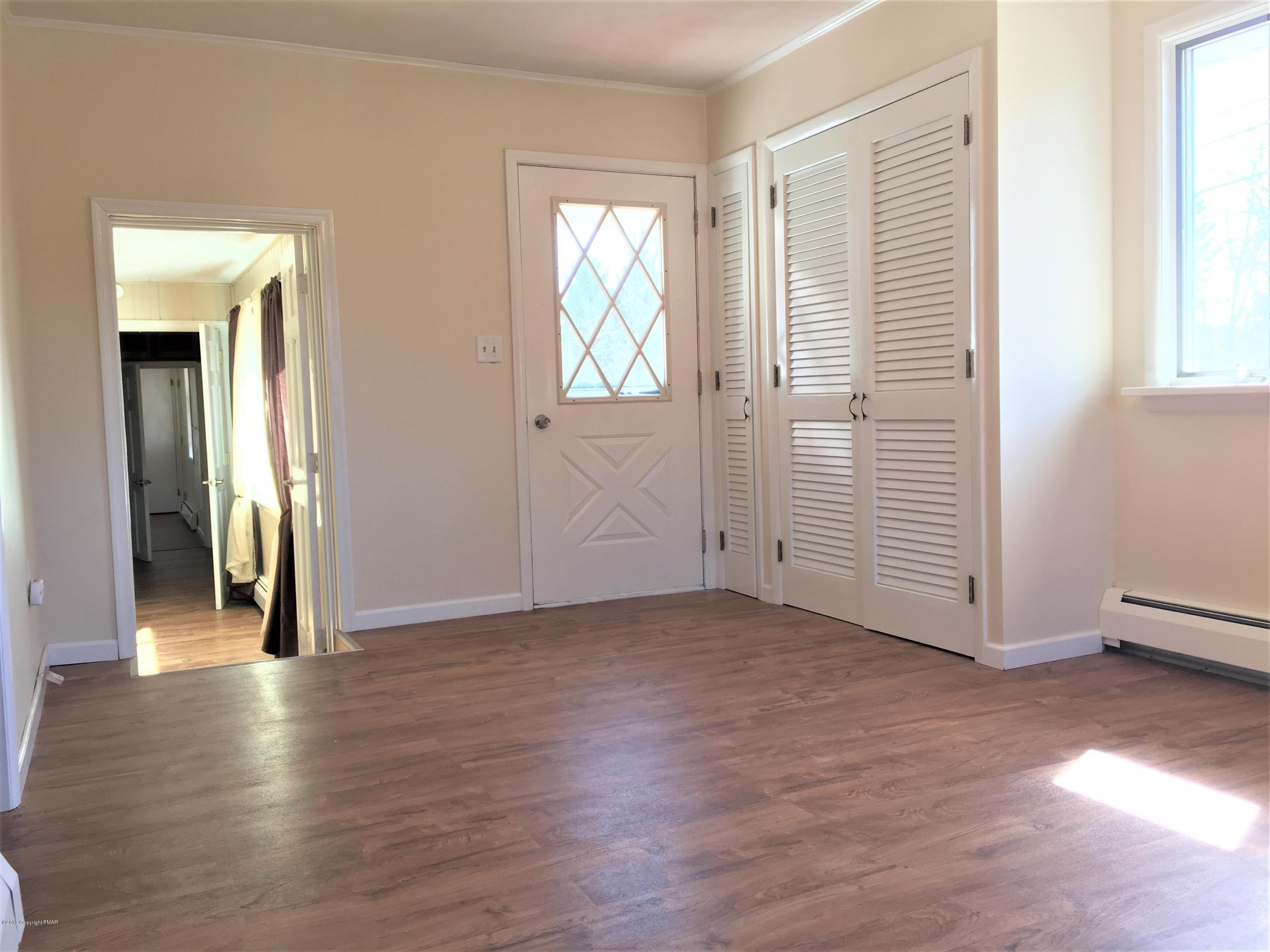 5736 Neola Road Stroudsburg, PA 18360 - Photo 8 of 37 an empty room with wooden floor and windows