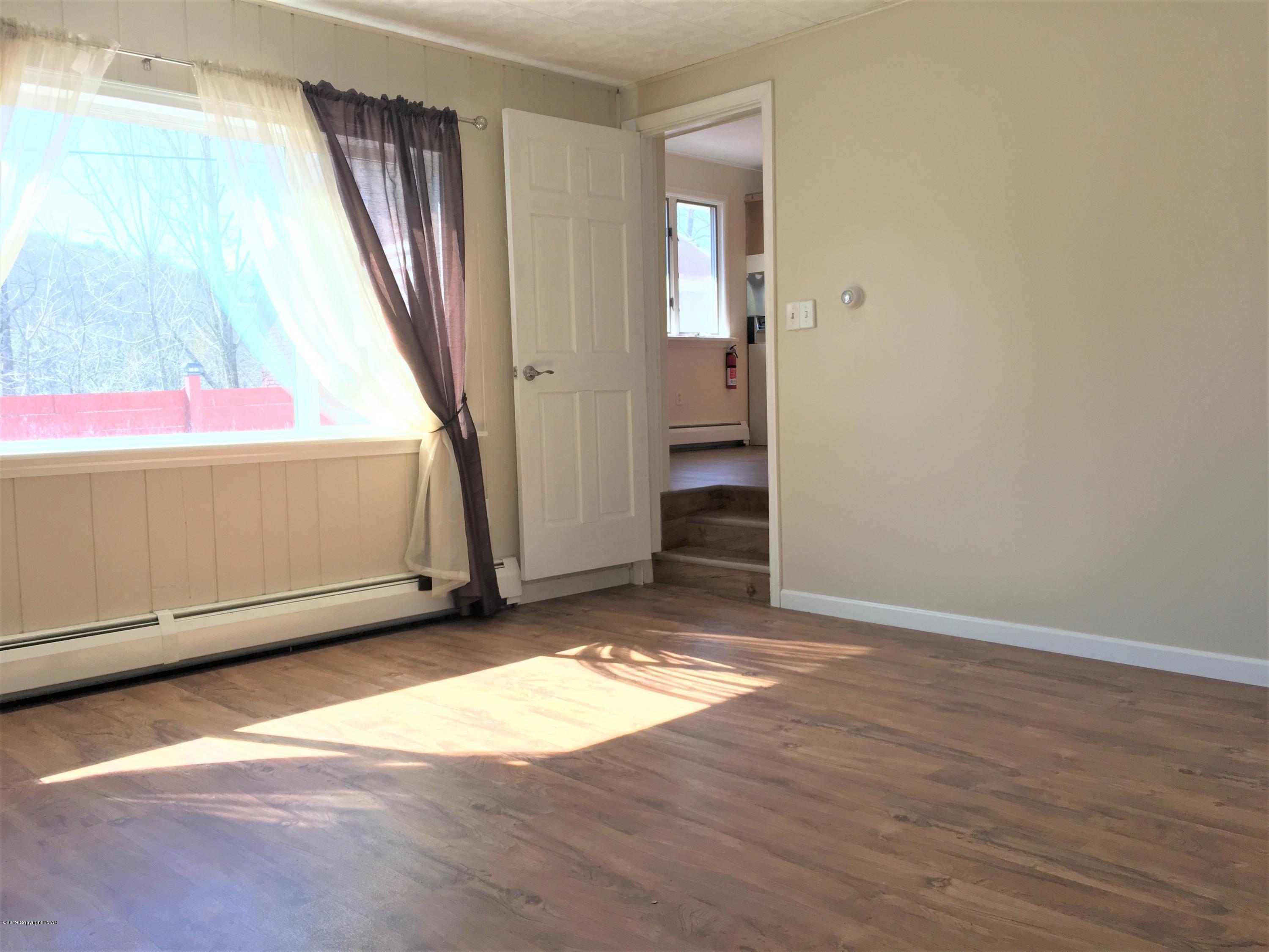 5736 Neola Road Stroudsburg, PA 18360 - Photo 10 of 37 an empty room with wooden floor and windows