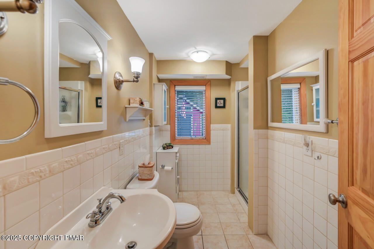 229 3rd Street Pocono Pines, PA 18350 - Photo 12 of 21 a bathroom with a sink a toilet and shower