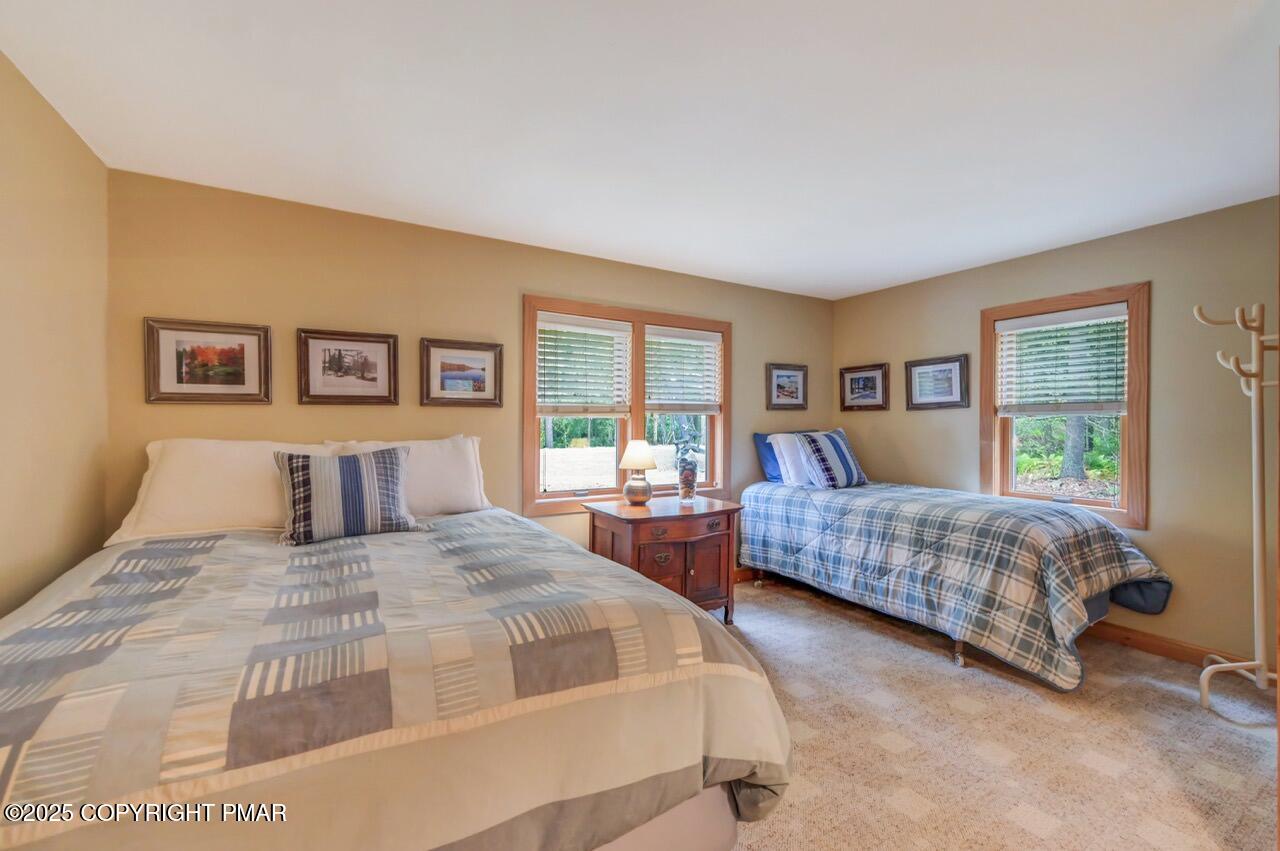 229 3rd Street Pocono Pines, PA 18350 - Photo 13 of 21 a bedroom with a large bed and a two couches chair