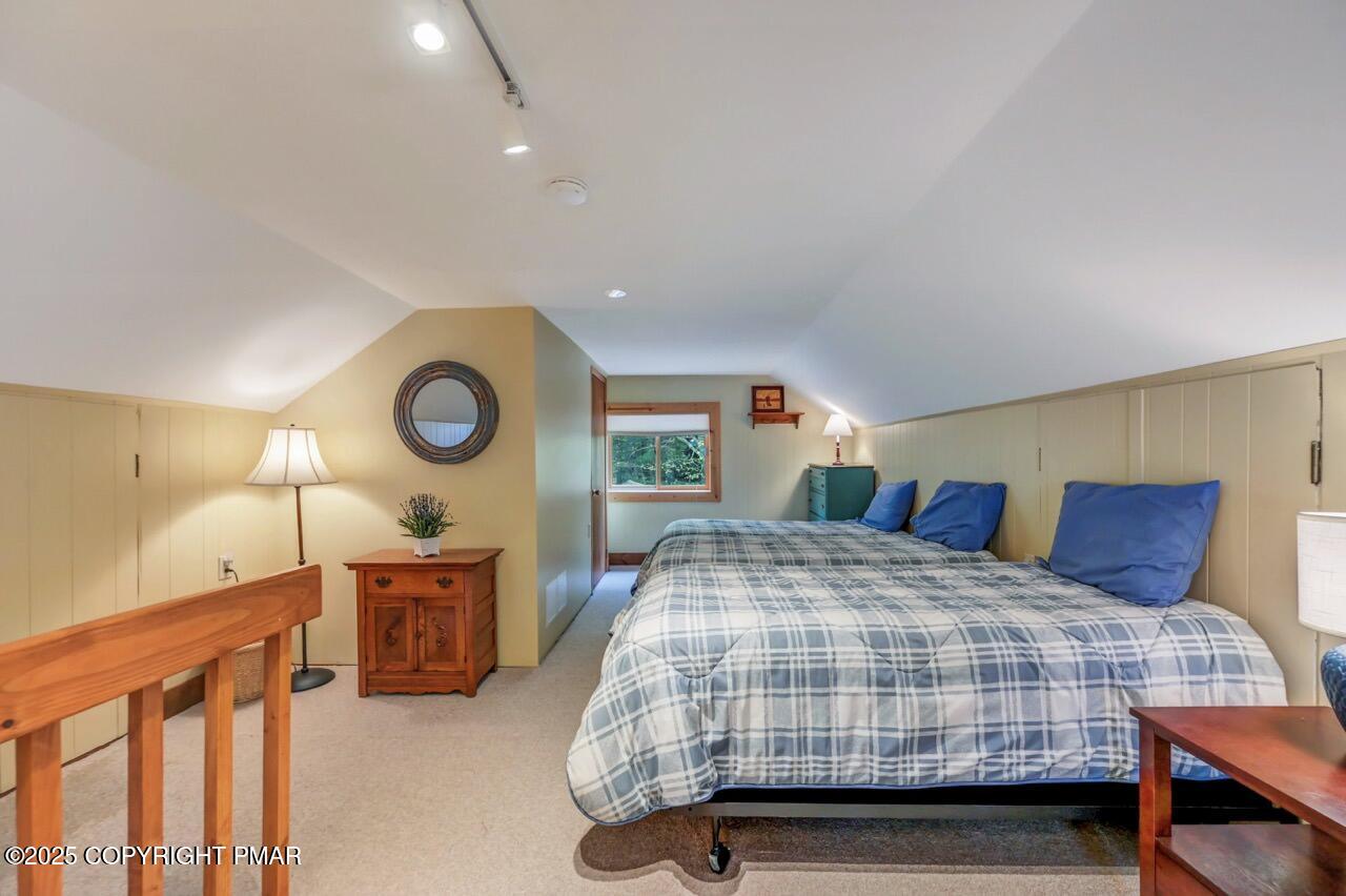 229 3rd Street Pocono Pines, PA 18350 - Photo 15 of 21 a bedroom with a bed and lamp with window
