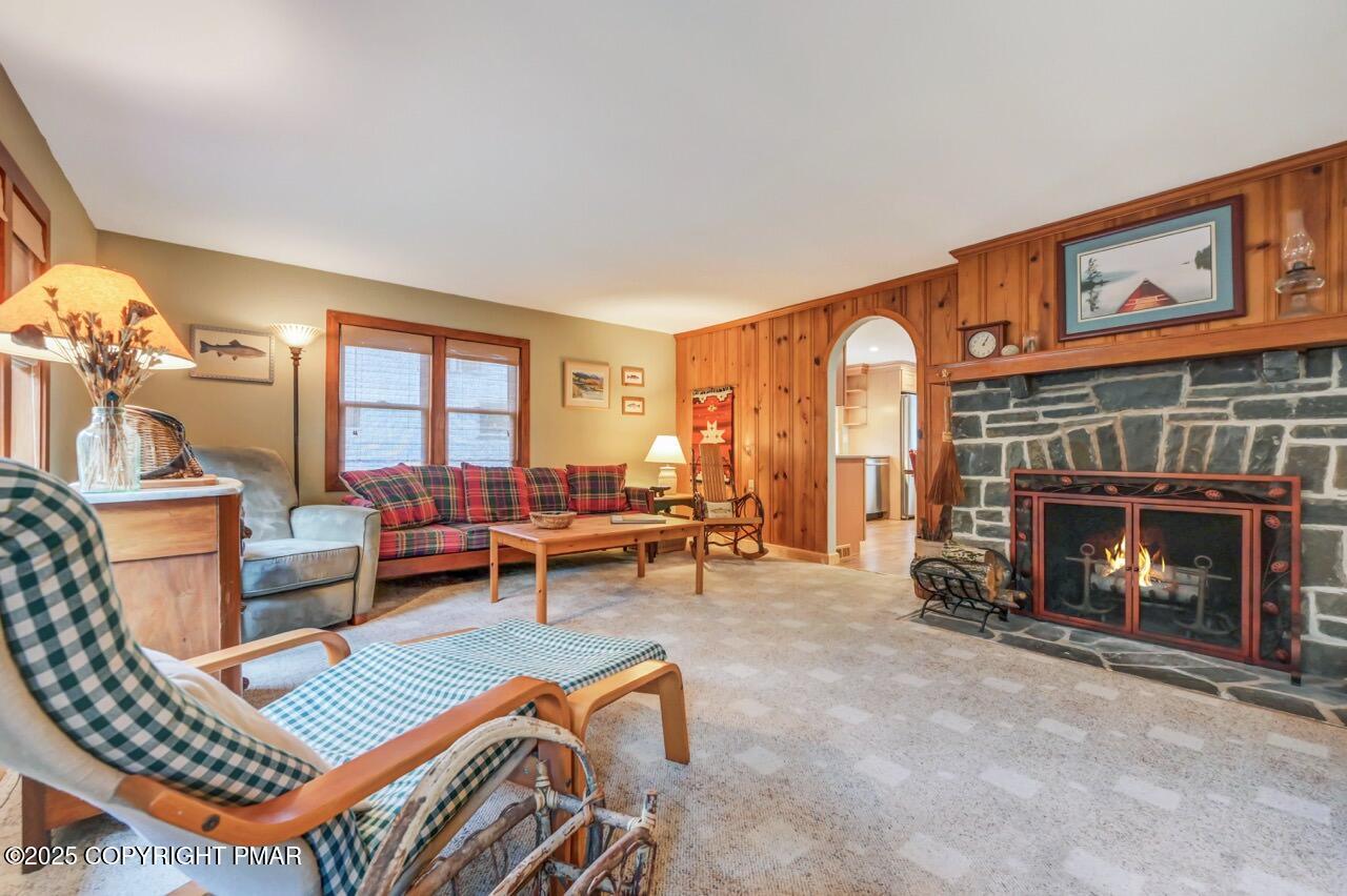 229 3rd Street Pocono Pines, PA 18350 - Photo 3 of 21 a living room with furniture a fireplace and a large window
