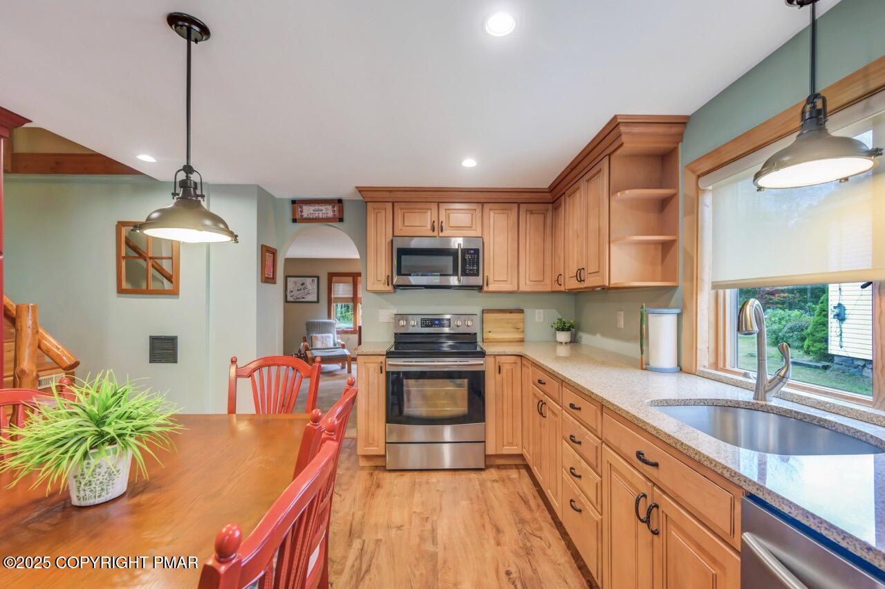 229 3rd Street Pocono Pines, PA 18350 - Photo 8 of 21 a kitchen with stainless steel appliances granite countertop a sink a stove and a wooden floors