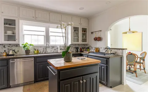 a kitchen with a stove a sink and a refrigerator