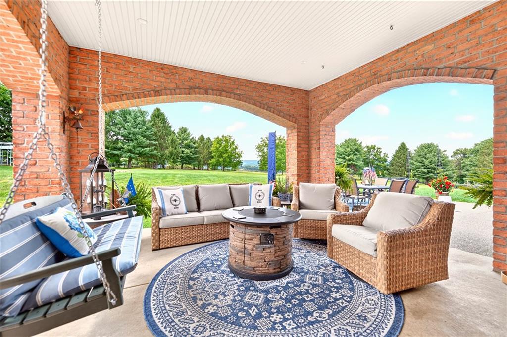 486 Settler Road Ligonier, PA 15658 - Photo 44 of 49 When you walk out the new sliding glass door from your Family Room, you can enjoy one of 3 concrete patios. This one is brick, and covered, the other two are open, which were both built in 2021.