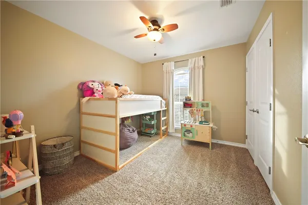 a bed room with a bed and a chandelier