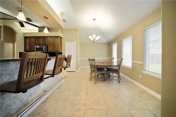 a view of a dining room with furniture window and outside view