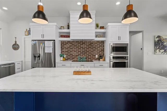 a bathroom with a sink and a chandelier