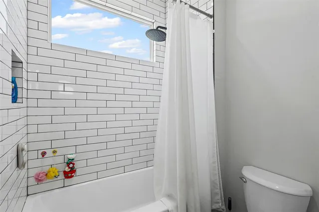 a bathroom with a bathtub and toilet