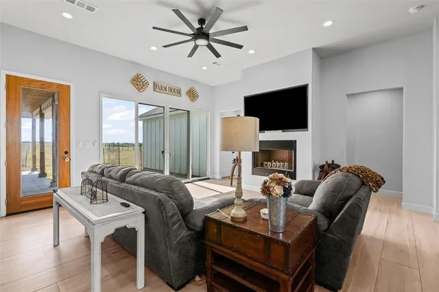 a living room with furniture a fireplace and a flat screen tv