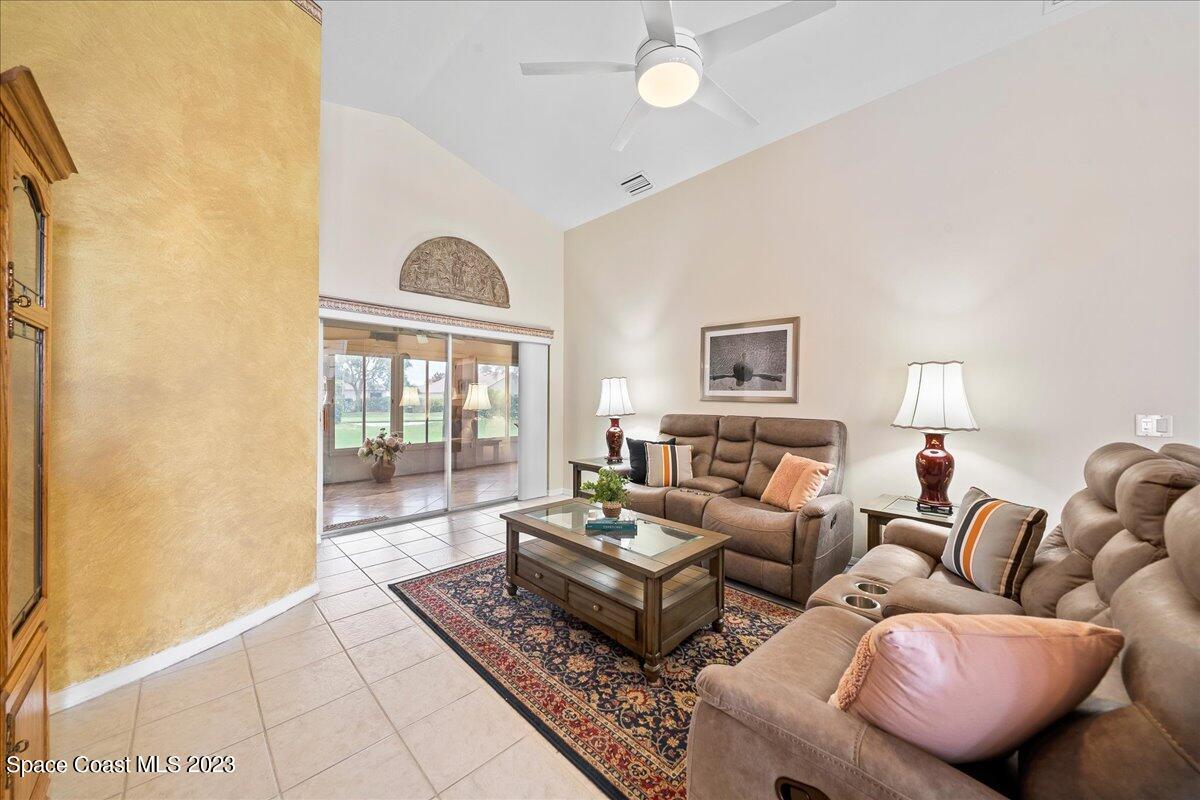 1643 Keys Gate Drive Melbourne, FL 32940 - Photo 15 of 43 a living room with furniture a large window and a rug