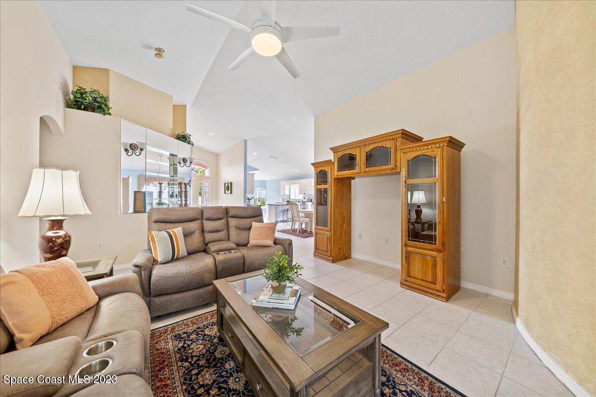 1643 Keys Gate Drive Melbourne, FL 32940 - Photo 16 of 43 a living room with furniture and a chandelier